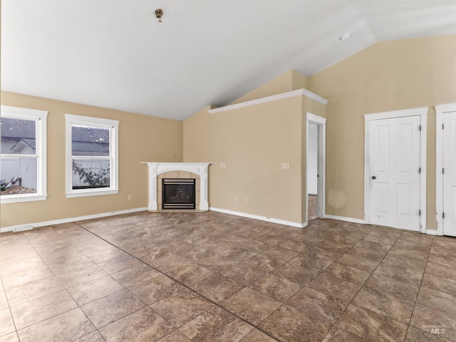 unfurnished living room featuring a tiled fireplace and lofted ceiling