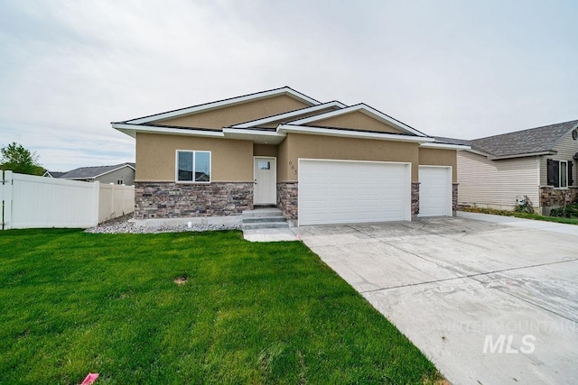 665 Emma Ct, Idaho Falls, ID 83404 - ranch-style house featuring stone siding, stucco siding, an attached garage, and driveway