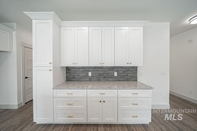 665 Emma Ct, Idaho Falls, ID 83404 - kitchen featuring backsplash, white cabinets, light stone countertops, and dark wood finished floors