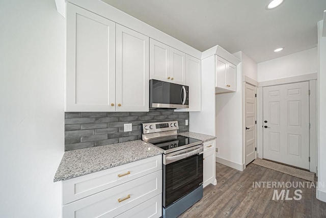 665 Emma Ct, Idaho Falls, ID 83404 - kitchen with appliances with stainless steel finishes, decorative backsplash, white cabinetry, light stone countertops, and recessed lighting