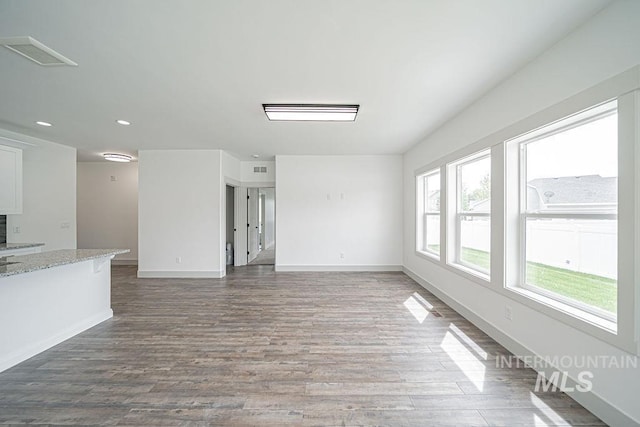665 Emma Ct, Idaho Falls, ID 83404 - unfurnished living room featuring wood finished floors, baseboards, and recessed lighting