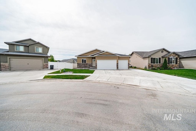 665 Emma Ct, Idaho Falls, ID 83404 - view of front of property with stone siding, driveway, and stucco siding