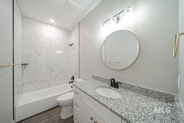 665 Emma Ct, Idaho Falls, ID 83404 - bathroom featuring toilet, vanity, shower / bathtub combination, and wood finished floors