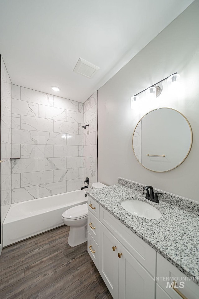 665 Emma Ct, Idaho Falls, ID 83404 - bathroom featuring toilet, shower / tub combination, vanity, and wood finished floors