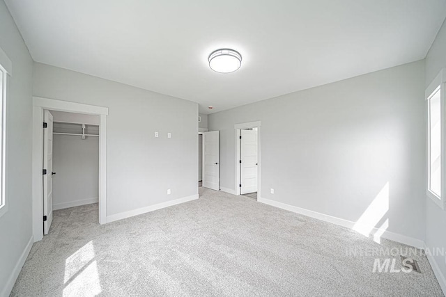 665 Emma Ct, Idaho Falls, ID 83404 - unfurnished bedroom with carpet, baseboards, a walk in closet, and a closet