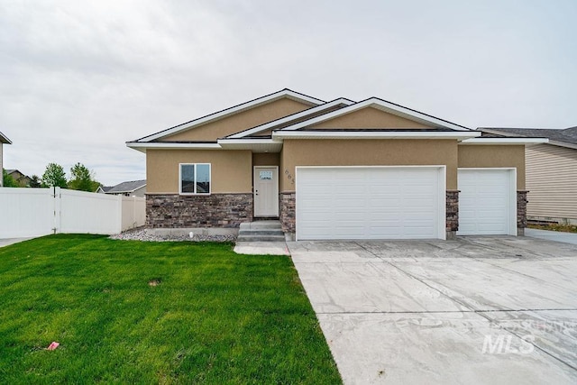 665 Emma Ct, Idaho Falls, ID 83404 - view of front of house featuring stone siding, stucco siding, a garage, and driveway