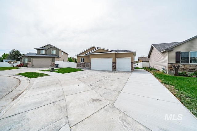 665 Emma Ct, Idaho Falls, ID 83404 - view of front of house featuring stone siding, stucco siding, and driveway