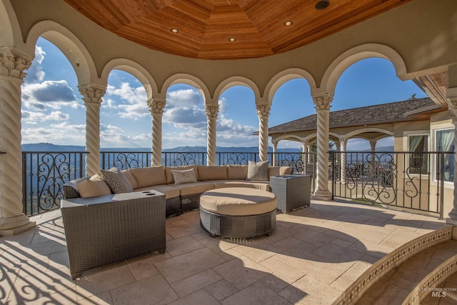 view of patio with outdoor lounge area and a water view