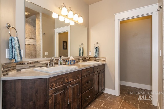4519 Middlesboro Way, Caldwell, ID 83607 - bathroom with backsplash, tile patterned floors, double vanity, and baseboards