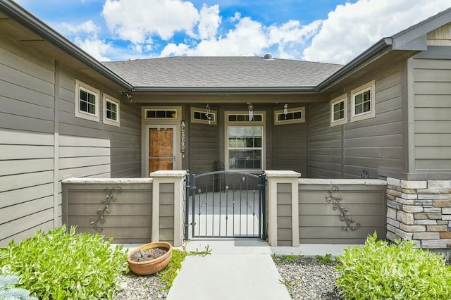 4519 Middlesboro Way, Caldwell, ID 83607 - view of exterior entry featuring a gate, fence, a porch, roof with shingles, and stone siding