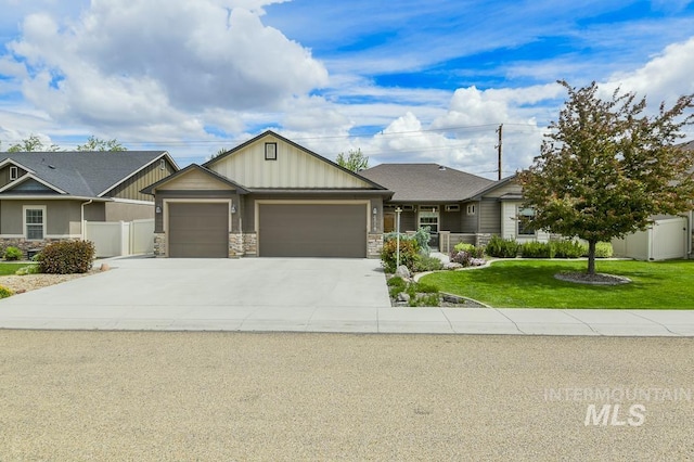 4519 Middlesboro Way, Caldwell, ID 83607 - view of front of house featuring an attached garage, concrete driveway, board and batten siding, and stone siding