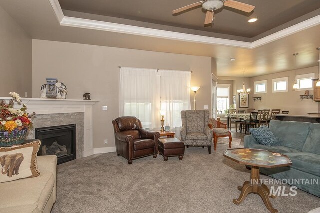 4519 Middlesboro Way, Caldwell, ID 83607 - living room with a ceiling fan, light colored carpet, crown molding, a raised ceiling, and a premium fireplace