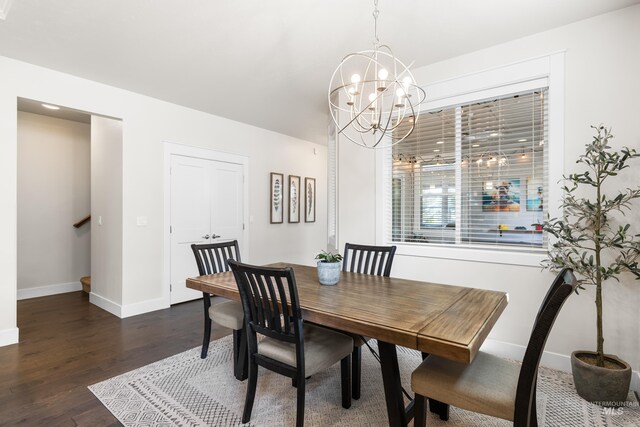 dining space featuring an inviting chandelier, baseboards, dark wood-style flooring, and stairs
