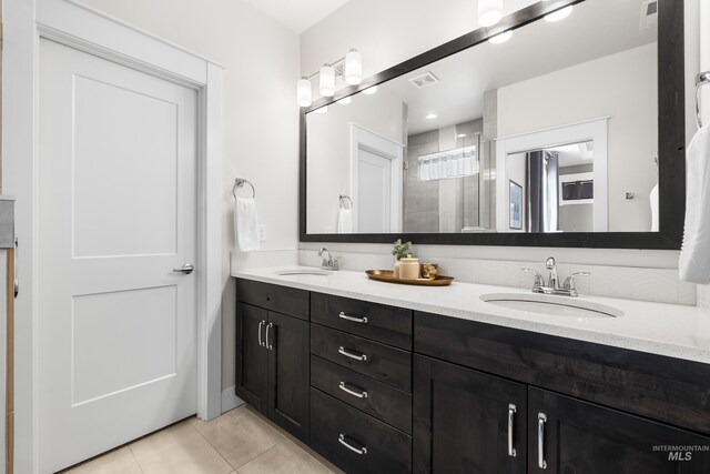 full bath with tile patterned floors, visible vents, and a sink