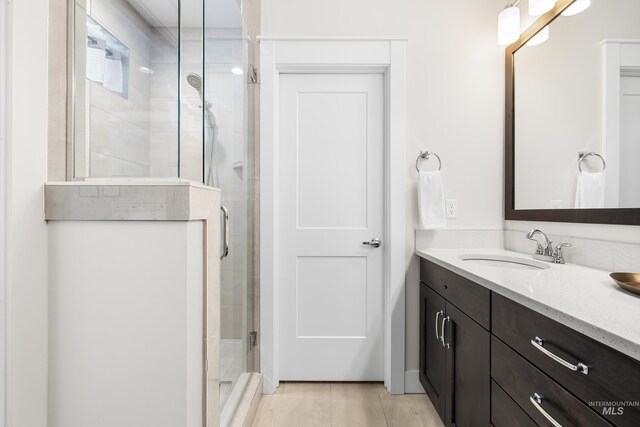 bathroom with vanity and a stall shower