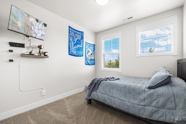 bedroom featuring baseboards, carpet flooring, and visible vents