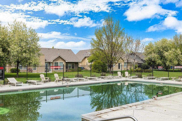 pool featuring a patio and fence
