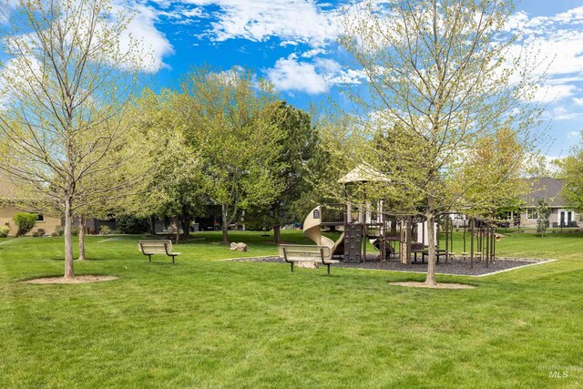 surrounding community with a lawn and playground community