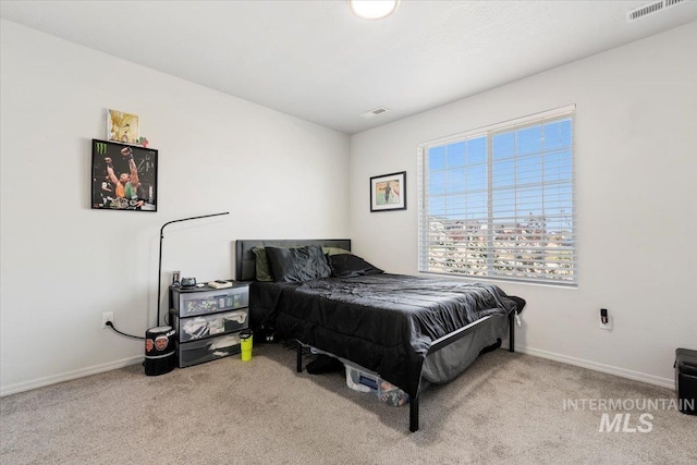 bedroom with baseboards, carpet flooring, and visible vents
