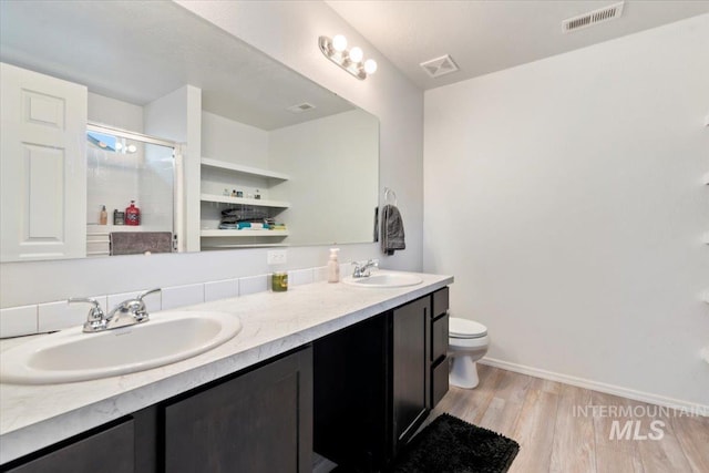 full bathroom with a sink, toilet, and visible vents