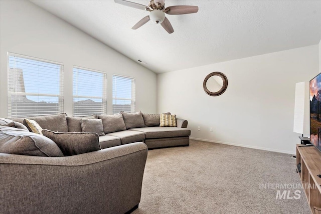 living area with carpet floors, a ceiling fan, baseboards, and lofted ceiling