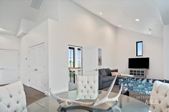 carpeted living area featuring high vaulted ceiling, recessed lighting, and baseboards