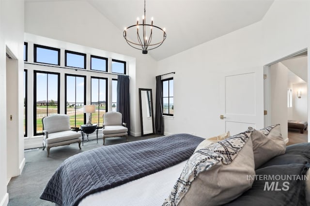 bedroom featuring a chandelier, high vaulted ceiling, carpet floors, and baseboards