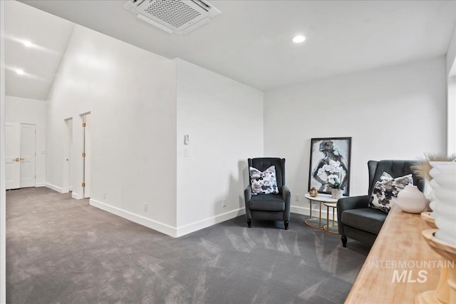 sitting room with lofted ceiling, recessed lighting, carpet flooring, visible vents, and baseboards