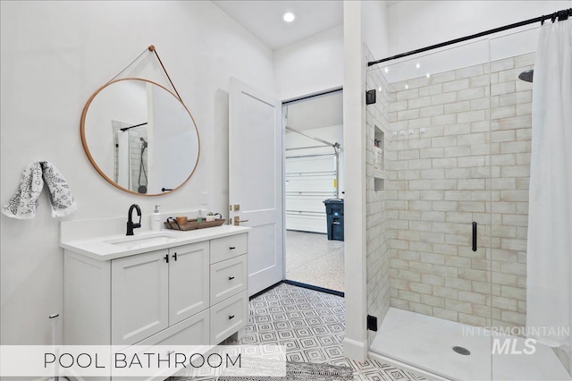 full bath with a stall shower and vanity