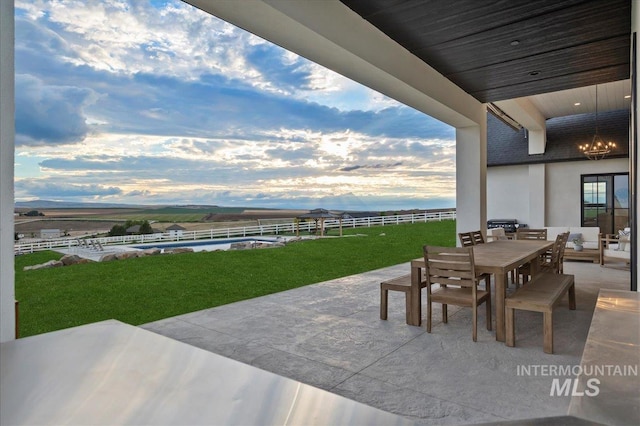 view of patio with outdoor dining space, an outdoor pool, and fence