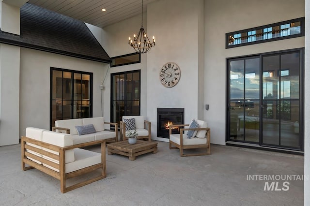 view of patio with an outdoor living space with a fireplace