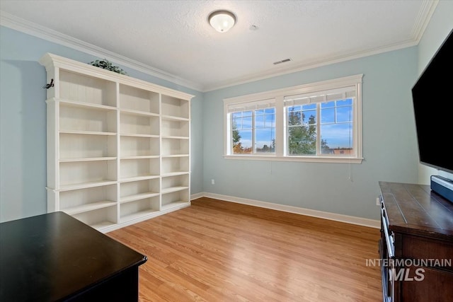 unfurnished office with light hardwood / wood-style flooring, ornamental molding, and a textured ceiling