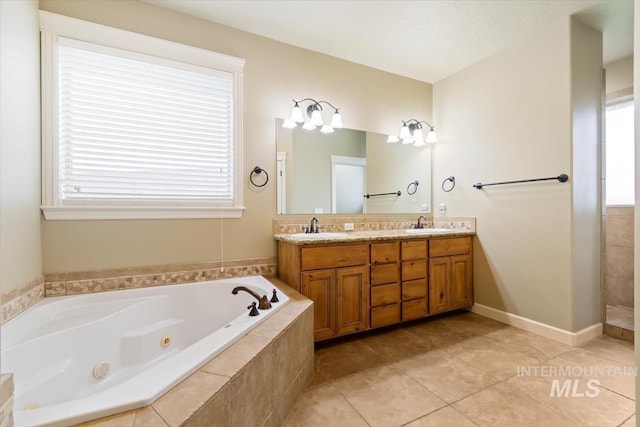 bathroom with vanity, tiled tub, a wealth of natural light, and tile patterned floors