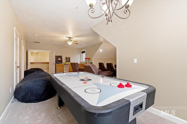 playroom featuring ceiling fan, carpet floors, and a textured ceiling