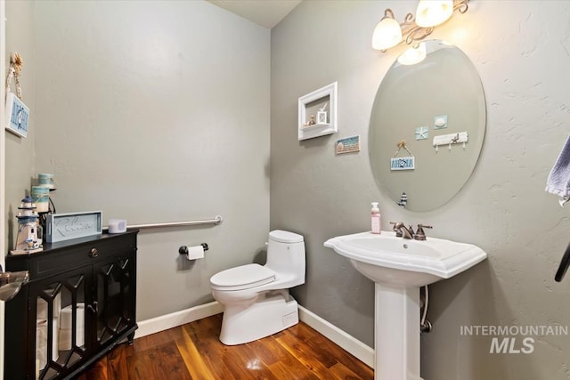 bathroom with sink, wood-type flooring, and toilet