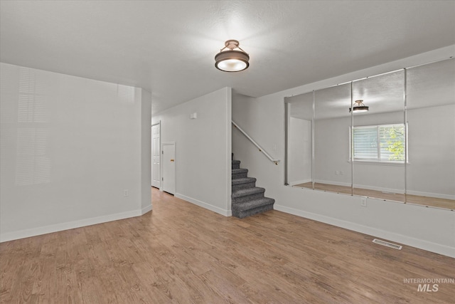 1420 S Denver, Boise, ID 83706 - empty room with stairs, wood finished floors, and baseboards