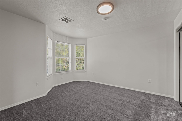 1420 S Denver, Boise, ID 83706 - unfurnished room with dark carpet, baseboards, and a textured ceiling