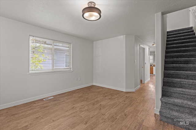 1420 S Denver, Boise, ID 83706 - empty room with stairway, light wood finished floors, and baseboards
