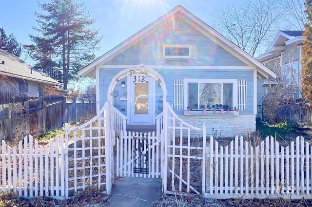 bungalow-style home with fence