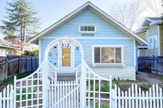 bungalow-style home with fence private yard