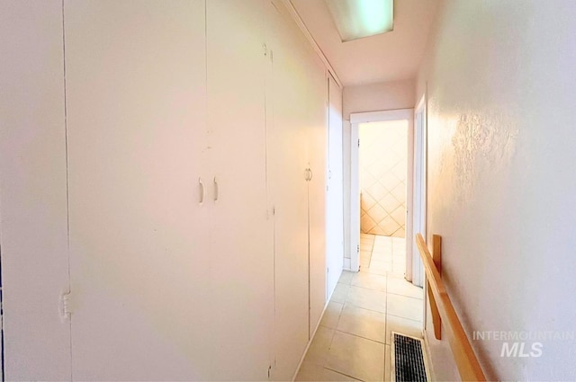 hallway featuring light tile patterned floors and visible vents