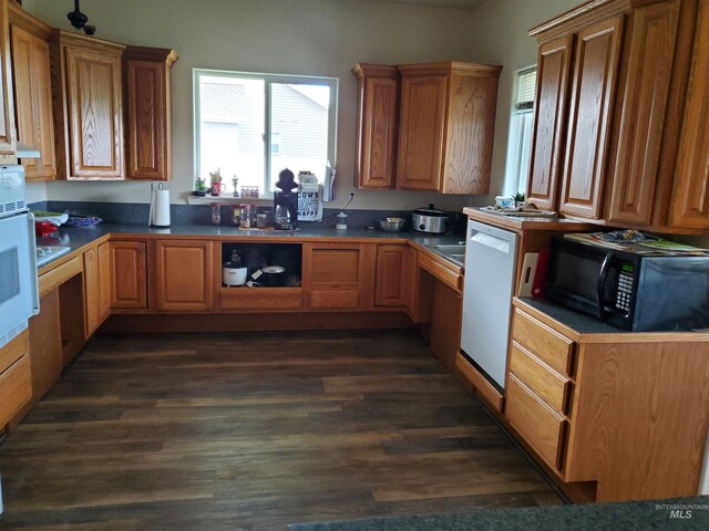 1441 Marie Dr, Gooding, ID 83330 - kitchen featuring black microwave, white dishwasher, dark wood-style floors, and brown cabinetry
