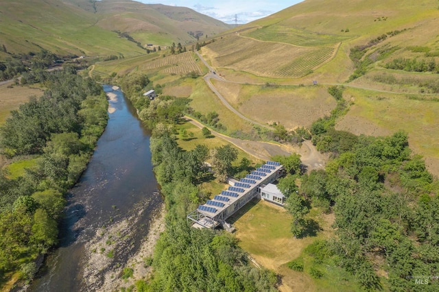 aerial view of property's location featuring a nearby body of water and rural landscape