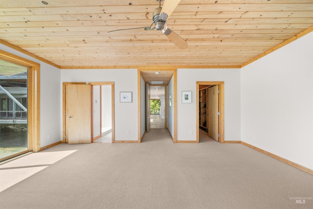 empty room with wooden ceiling, light carpet, baseboards, and ceiling fan