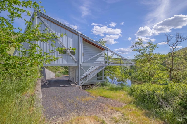 view of property exterior featuring stairway and board and batten siding