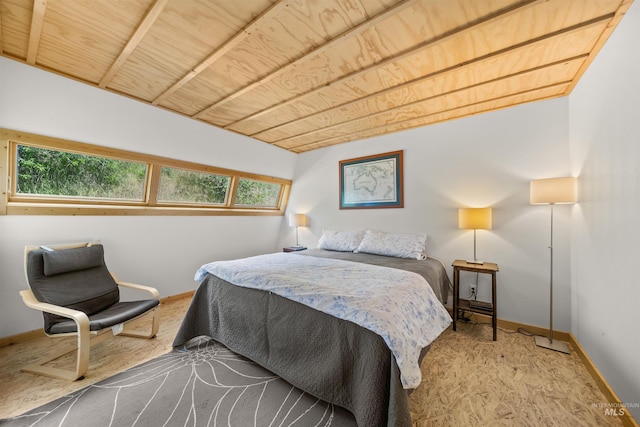 bedroom with baseboards, wood ceiling, and lofted ceiling