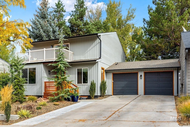 view of front of property featuring a balcony and a garage