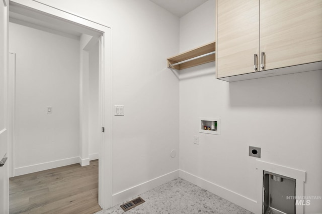 washroom with hookup for a washing machine, cabinet space, visible vents, hookup for an electric dryer, and baseboards