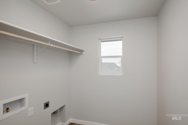 laundry room with hookup for a washing machine, laundry area, hookup for an electric dryer, and baseboards