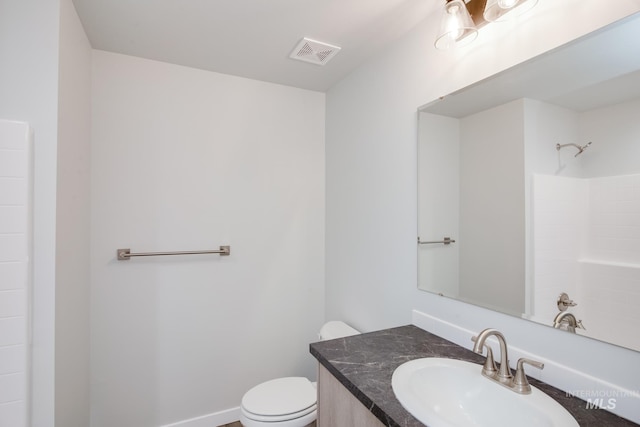 bathroom featuring baseboards, visible vents, toilet, walk in shower, and vanity